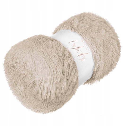 Sammenrullet lys beige fuskepelspledd med myk, fluffy tekstur