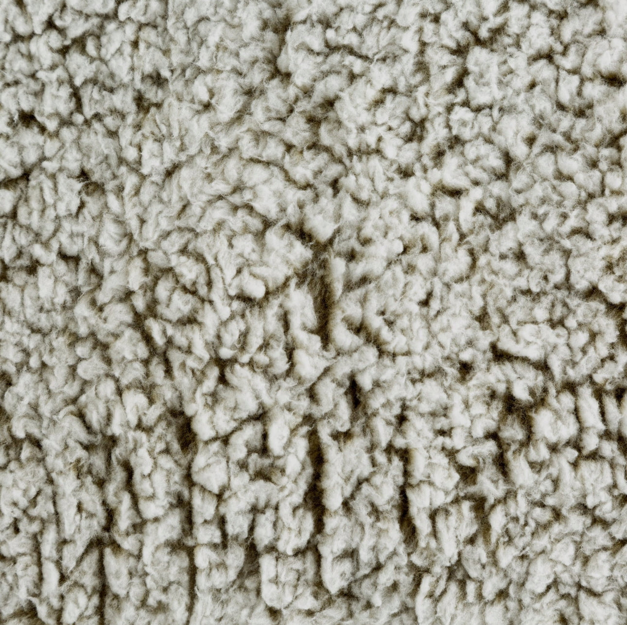Nærbilde av bouclé-tekstur i beige med fluffy, tettvevd overflate